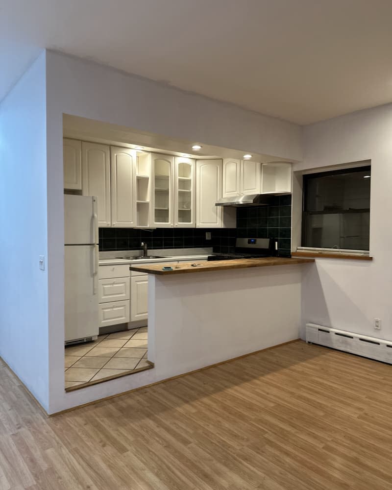 Empty white kitchen after repainting before moving out