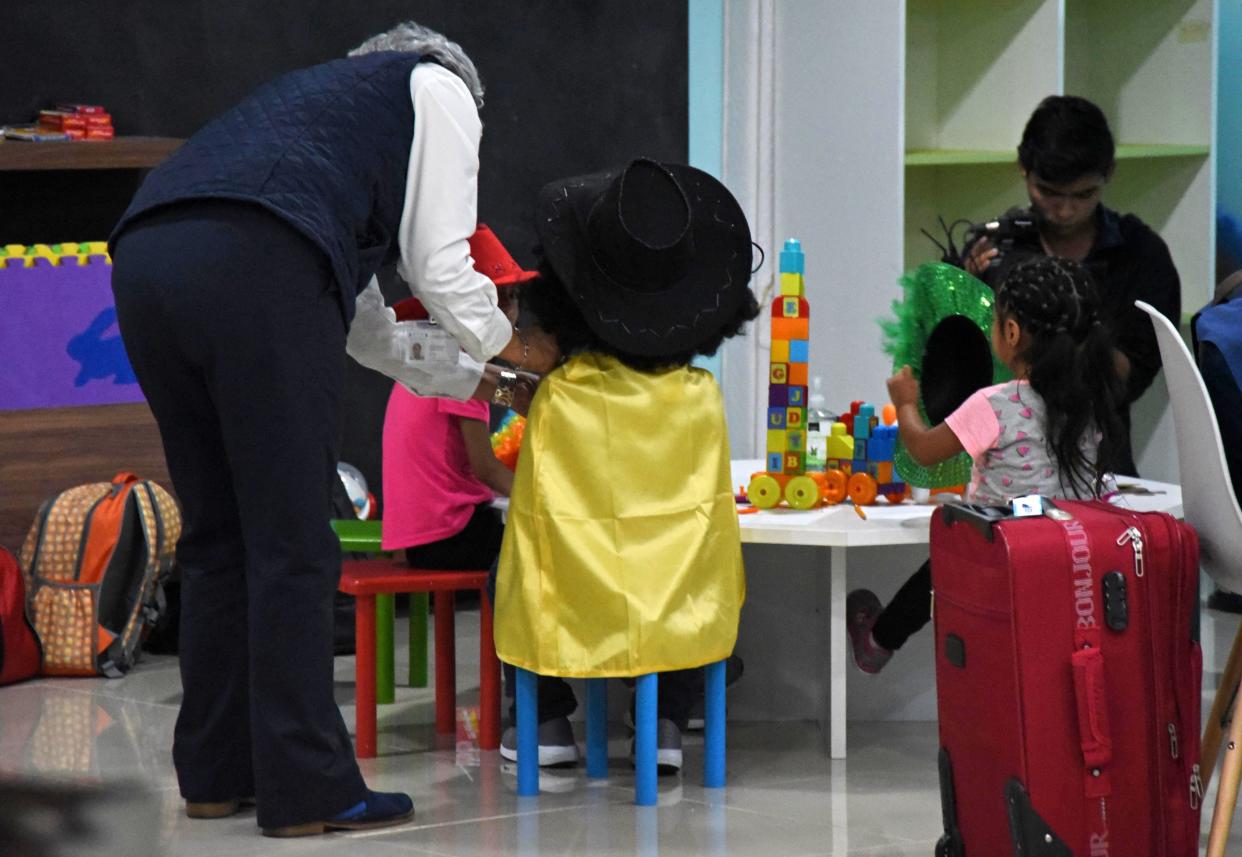 Three migrant minors who had been separated from their family on the U.S. border play in a welcome room upon arrival at La Aurora airport in Guatemala City on Aug. 7. (Photo: ORLANDO ESTRADA via Getty Images)