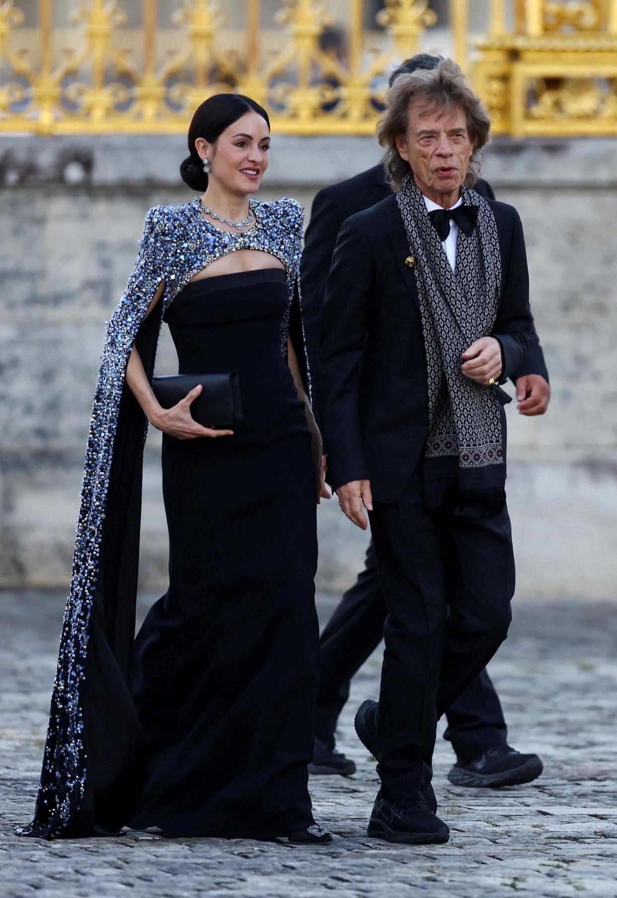 Rolling Stones band member Mick Jagger and Melanie Hamrick arrive to attend a state dinner in honor of Britain's King Charles and Queen Camilla at the Chateau de Versailles (REUTERS)