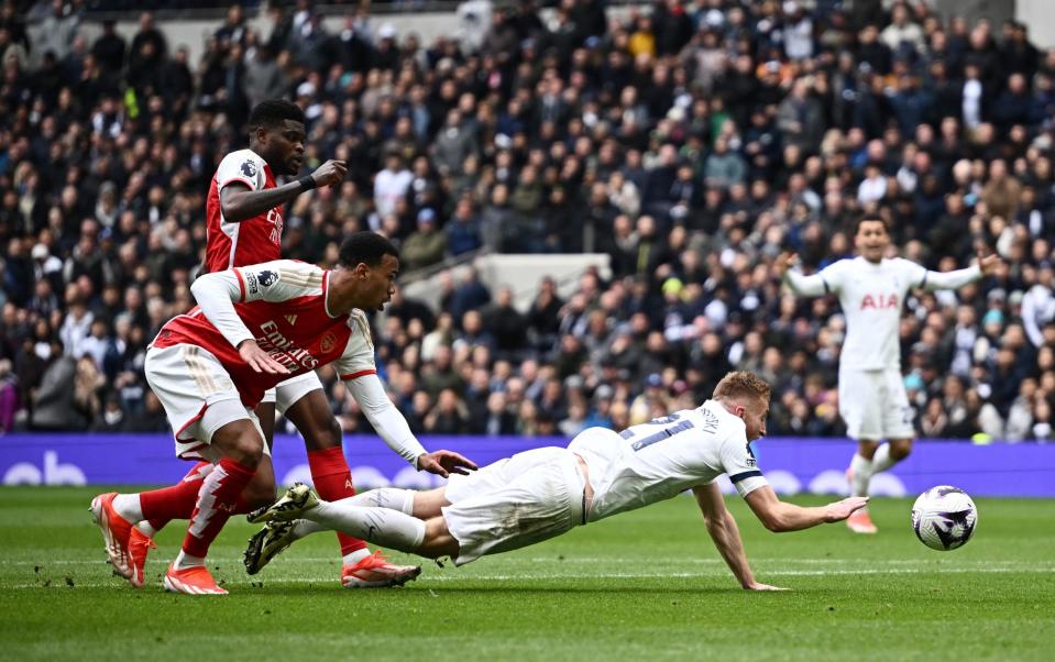 Dejan Kulusevski goes down inside the Arsenal box