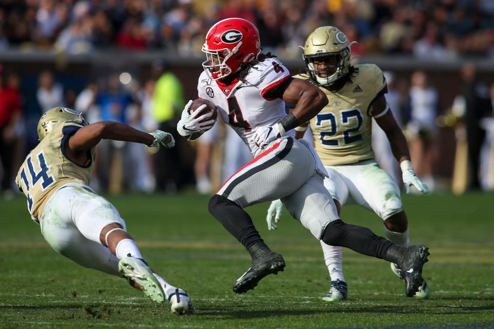 Nov 30, 2019; Atlanta, GA, USA; Georgia Bulldogs running back James Cook (4) runs the ball against the Georgia Tech Yellow Jackets in the second half at Bobby Dodd Stadium. Mandatory Credit: Brett Davis-USA TODAY Sports