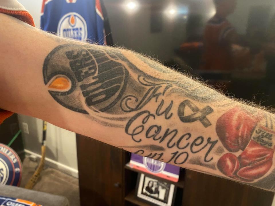 Tattoos of the Edmonton Oilers logo, a 'FU' to cancer and his wife and daughter's name are all side by side by side on Troy Kocur's arm.