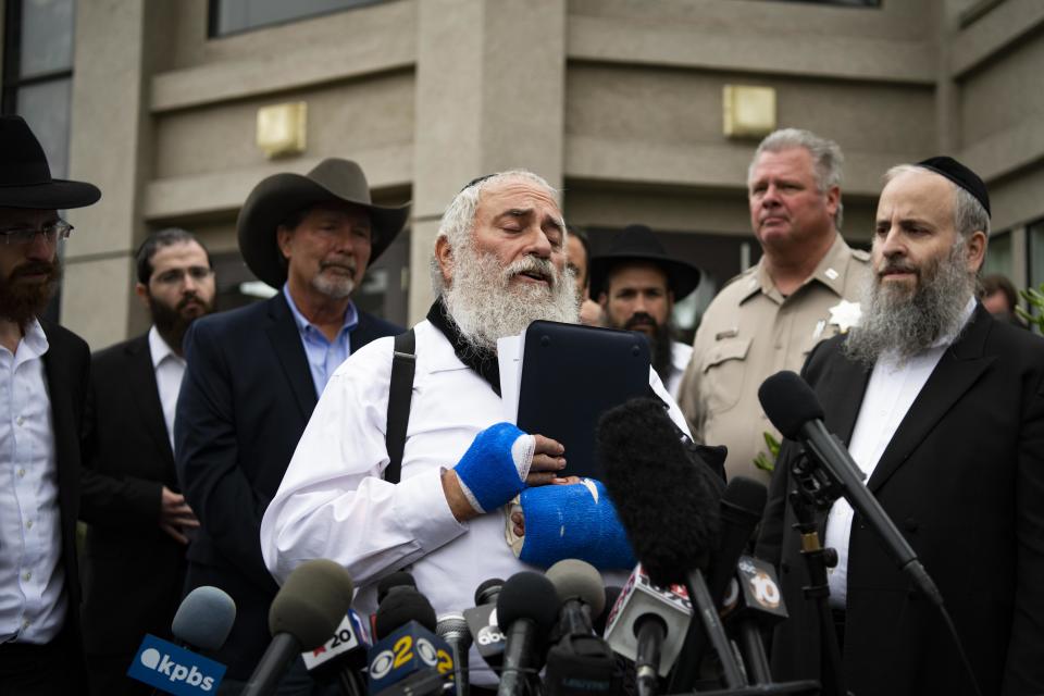 Rabbi Yisroel Goldstein speaks to reporters on Sunday in front of Chabad of Poway synagogue in California.