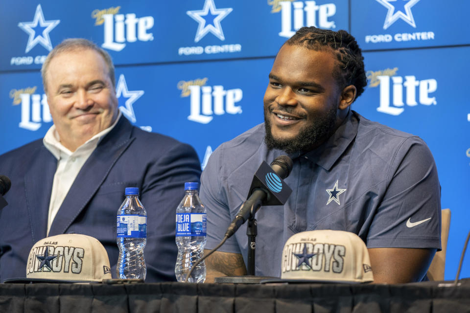 Dallas Cowboys first round draft pick Mazi Smith, a defensive tackle from Michigan, speaks to the media as head coach Mike McCarthy listens during a press conference Friday, April 28, 2023, at the Dallas Cowboys headquarters in Frisco, Texas. (AP Photo/Jeffrey McWhorter)