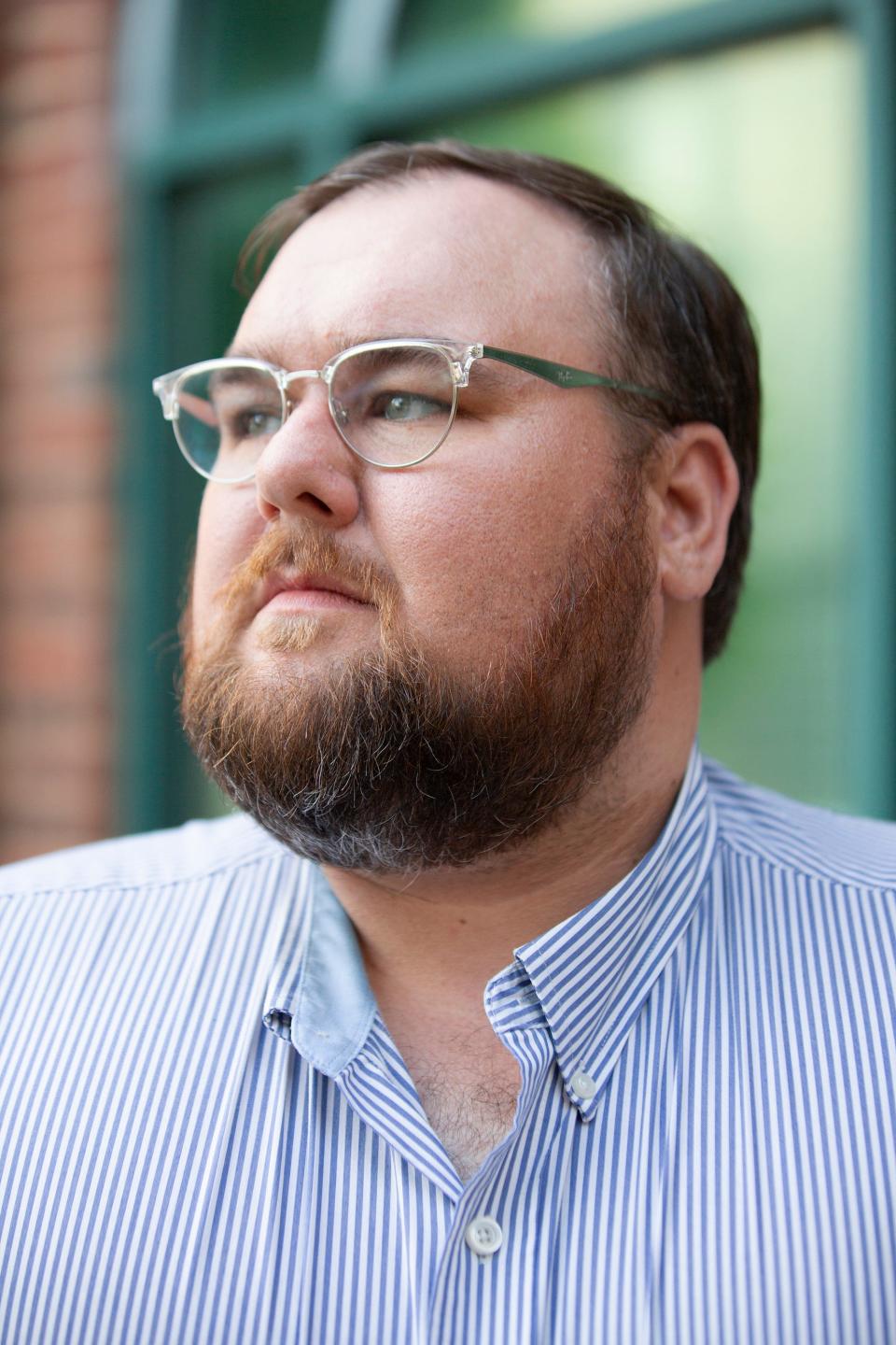 Adam Southern poses on the Columbia courthouse sqaure after reseigning from his position as the director of the Maury County Library on Tuesday, June 5, 2019.