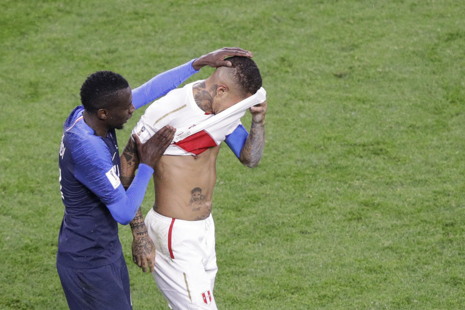 End of the road: Peru’s Paolo Guerrero is comforted by France’s Blaise Matuidi