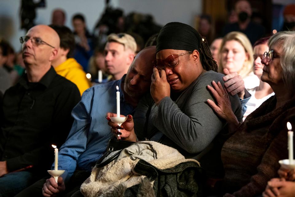 Tyrice Kelley, center right, a performer at Club Q, is comforted during a service held at All Souls Unitarian Church following a fatal shooting at the gay nightclub, in Colorado Springs, Colorado.