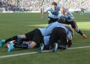 Players of Uruguay celebrate their team's second goal after teammate Diego Godin scored against Bolivia during their 2018 World Cup qualifying soccer match at the Hernando Siles Stadium in La Paz, Bolivia October 8, 2015. REUTERS/David Mercado