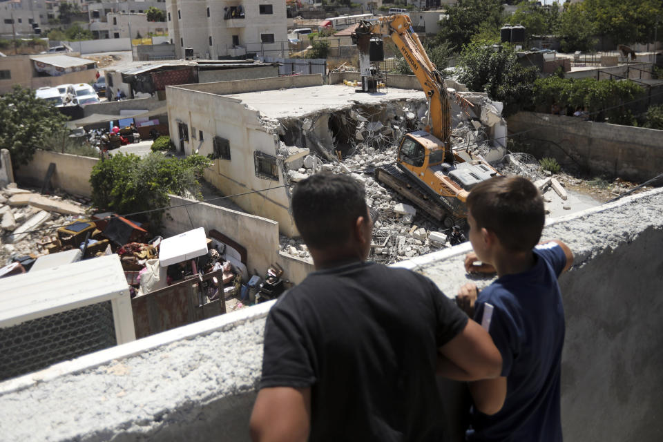 Israeli authorities demolish a Palestinian owned house in east Jerusalem, Wednesday, Aug. 21, 2019. Jerusalem's municipality has carried out the court-ordered demolition of what it said was an illegally built Palestinian home in the city's eastern sector. Jerusalem's Palestinian population has long complained that it faces discriminatory housing policies that favor Jews. They say it is virtually impossible to get a building permit and have no choice but to build without them.(AP Photo/Mahmoud Illean)