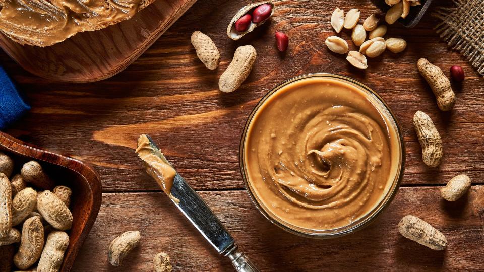 A view of peanut butter and peanuts on a table