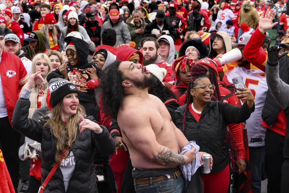 Fans dance to the music during the Kansas City Chiefs' victory celebration and parade in Kansas City, Mo., Wednesday, Feb. 15, 2023. The Chiefs defeated the Philadelphia Eagles Sunday in the NFL Super Bowl 57 football game. (AP Photo/Reed Hoffmann)