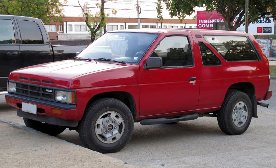 <p>One look at today’s soft-core Nissan Pathfinder crossover and it's almost impossible to see the lineage that dates back to the rugged original. The Pathfinder jumped into the crowded small SUV pool halfway through the 1986 model year and was instantly embraced by four-wheel-drive enthusiasts. That’s because Nissan engineered the Pathfinder to fit large 31x10.50-R-15 tires under its blistered fenders. So equipped, the Nissan could tackle trails better than most of its competition. Under the hood was a choice of a 2.4-liter four-cylinder or a 145-hp 3.0-liter V-6-a detuned version of the engine found in the 300ZX. The Pathfinder’s chassis was based on Nissan’s “Hardbody” pickup truck. But for the Pathfinder, Nissan chose to abandon the rear leaf springs in favor of a supple and modern coil-sprung suspension. Up until that point, it was mostly luxury SUVs that used coil springs. And that choice put the Pathfinder well ahead of its rivals in terms of ride and handling, on- and off-road. The two-door model used a fixed steel roof. And designers used a cool triangular side window glass treatment. As a practical hauler, the Pathfinder could swallow a four foot-by-eight foot sheet of plywood. The insulated steel roof helped make this Nissan quieter and more refined than the Toyota 4Runner. In 1990, the V-6 got stronger (153 horsepower) and Nissan added a four-door version that cleverly hid the passenger door handles and used the same chassis. It proved so popular that Nissan dropped the two-door in 1991. The Pathfinder became more luxurious with age, adding a fancy LE grade and a new interior in 1994, just one year before it was replaced.<br><br></p><p>The two-door Pathfinder was the most stylish. So the one to find would be the last one (1990) with the most horsepower. But the trouble with Pathfinders is simply finding them in any condition. Nissan sold nearly 80,000 of them in just the first two years. So it’s odd that so few remain. This generation Pathfinder seems to have been used particularly hard. And perhaps that’s a testimony to its durability. The good news is that they have remained cheap ($2000-$8000 depending on miles) and have proven to be hearty rigs. So these could be an excellent and trustworthy used 4WD vehicle for those on a limited budget. Aftermarket 4x4 parts for the Pathfinder and its pickup truck brethren (produced until 1998) can be found through <a rel="nofollow noopener" href="https://www.calmini.com" target="_blank" data-ylk="slk:Calmini;elm:context_link;itc:0;sec:content-canvas" class="link ">Calmini</a>, which offers suspension upgrades as well as drivetrain parts to make the original Pathfinder even more capable off-road.</p>