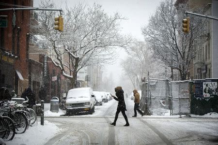 Pedestrians walk through a snow storm in New York March 5, 2015. REUTERS/Lucas Jackson