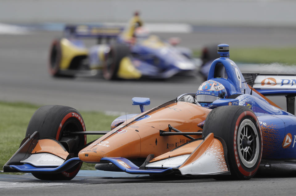 FILE - In this May 12, 2018, file photo, Scott Dixon, of New Zealand, heads through a turn during the IndyCar Grand Prix auto race at Indianapolis Motor Speedway in Indianapolis. NASCAR and IndyCar have postponed their weekend schedules at Atlanta Motor Speedway and St. Petersburg, Florida, due to concerns over the COVID-19 pandemic. NASCAR also postponed next week's race near Miami and IndyCar suspended the season through the end of April. (AP Photo/Darron Cummings, File)