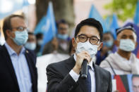 Hong Kong activist Nathan Law speaks as he takes part in a protest during the visit of Chinese Foreign Minister Wang Yi in Berlin, Germany, Tuesday, Sept. 1, 2020. German Foreign Minister Heiko Maas meets his Chinese counterpart at the foreign ministry guest house Villa Borsig for bilateral talks. (AP Photo/Markus Schreiber)