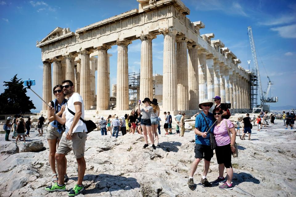 Tourists visit the ancient Acropolis hill
