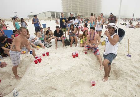 Chris Ewing (L) plays beer pong with Tom Brady (C) and Colin Anderson during spring break festivities in Panama City Beach, Florida March 12, 2015. REUTERS/Michael Spooneybarger