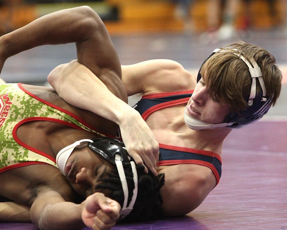 BNL junior Brax Huber locks in a hold on Jeffersonville's Nizaiah Carr at 138 pounds Saturday during the HHC Tournament at BNL Fieldhouse.