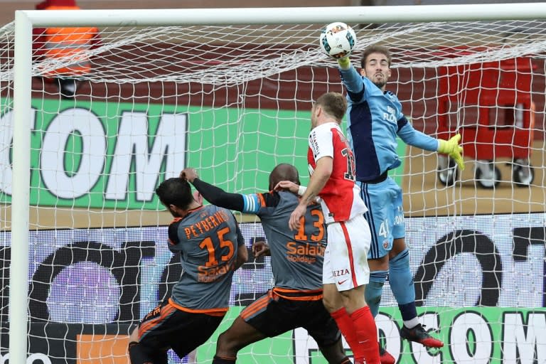 Lorient's French goalkeeper Benjamin Lecomte (R) vies with Monaco's French forward Valere Germain (C) during the French L1 football match between Monaco (ASM) and Lorient (FCL) on January 22, 2017 at the Louis II Stadium in Monaco