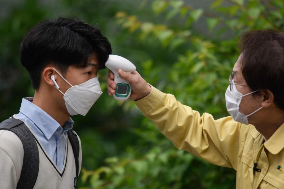 Students will be given temperature checks (AFP via Getty Images)