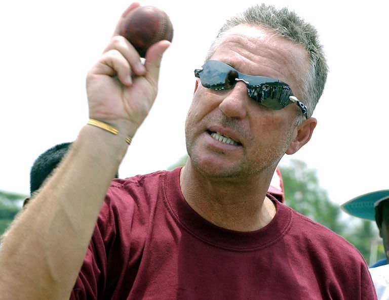 Former England cricket all-rounder Ian Botham teaches Sri Lankan schoolboys the art of fast bowling at the Galle International Cricket Stadium during a visit to Sri Lanka on April 20, 2005. Former England captains Botham and Nasser Hussain have led the tributes to their late predecessor Tony Greig, who died on Saturday at the age of 66