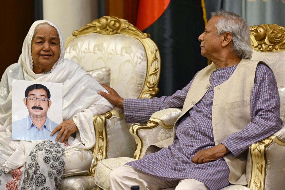 Bangladesh's caretaker government Muhammad Yunus consoles Hazera Khatun, who holds a portrait of her son Sajedul Islam Sumon, who went missing during Sheikh Hasina's rule, in Dhaka (AFP via Getty)