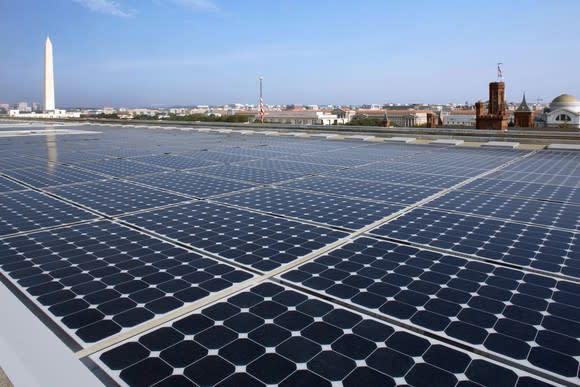 Rooftop solar installation with the Washington Monument in the background.