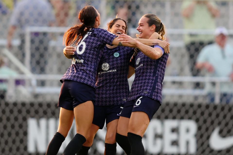 Racing Louisville FC midfielder Savannah DeMelo (7) celebrates with defender Carson Pickett (26) and midfielder Jaelin Howell (6) after scoring a goal in the first half against the Kansas City Current on May 17, 2023 at Lynn Family Stadium.