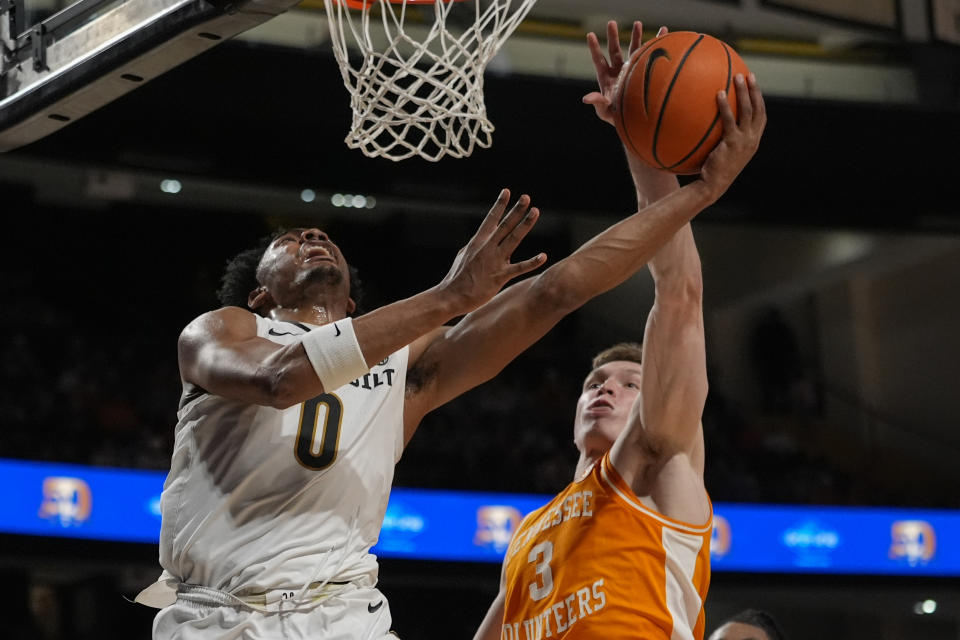 Tennessee guard Dalton Knecht (3) blocks a shot by Vanderbilt guard Tyrin Lawrence (0) during the second half of an NCAA college basketball game Saturday, Jan. 27, 2024, in Nashville, Tenn. Tennessee won 75-62. (AP Photo/George Walker IV)