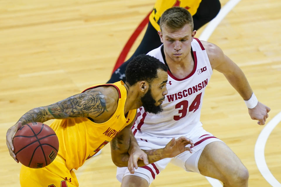 Maryland's Eric Ayala (5) drives against Wisconsin's Brad Davison (34) during the first half of an NCAA college basketball game Tuesday, Jan. 14, 2020, in Madison, Wis. (AP Photo/Andy Manis)