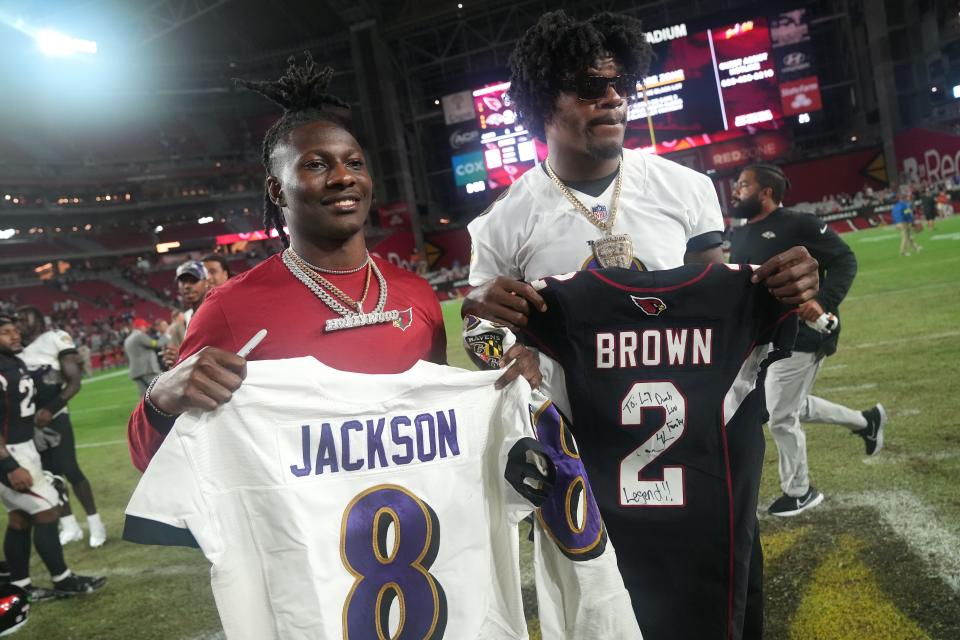 Aug 21, 2022; Glendale, AZ, United States; Arizona Cardinals wide receiver Marquise Brown poses for a photo with his former teammate, Baltimore Ravens quarterback Lamar Jackson at State Farm Stadium.