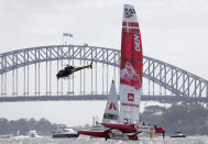 A helicopter flies near the Denmark boat as the prepare for the SailGP race on Sydney Harbour, Friday, Feb. 28, 2020. Britain leads the standings after the opening day while Australia and Japan were tied for second with 23 points each. (AP Photo/Rick Rycroft)