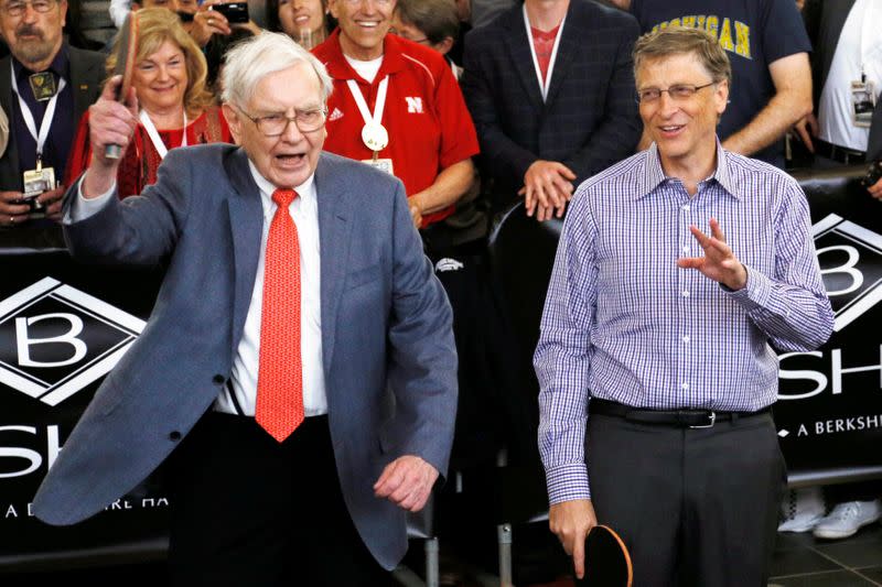 FILE PHOTO: Berkshire Hathaway CEO Warren Buffett gestures before a table tennis game with Microsoft Chairman Bill Gates in Omaha