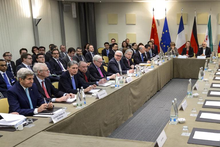 Officials wait for a meeting with officials from P5+1, the European Union and Iran ahead of the opening of a plenary session on Iran nuclear talks in Lausanne on March 31, 2015