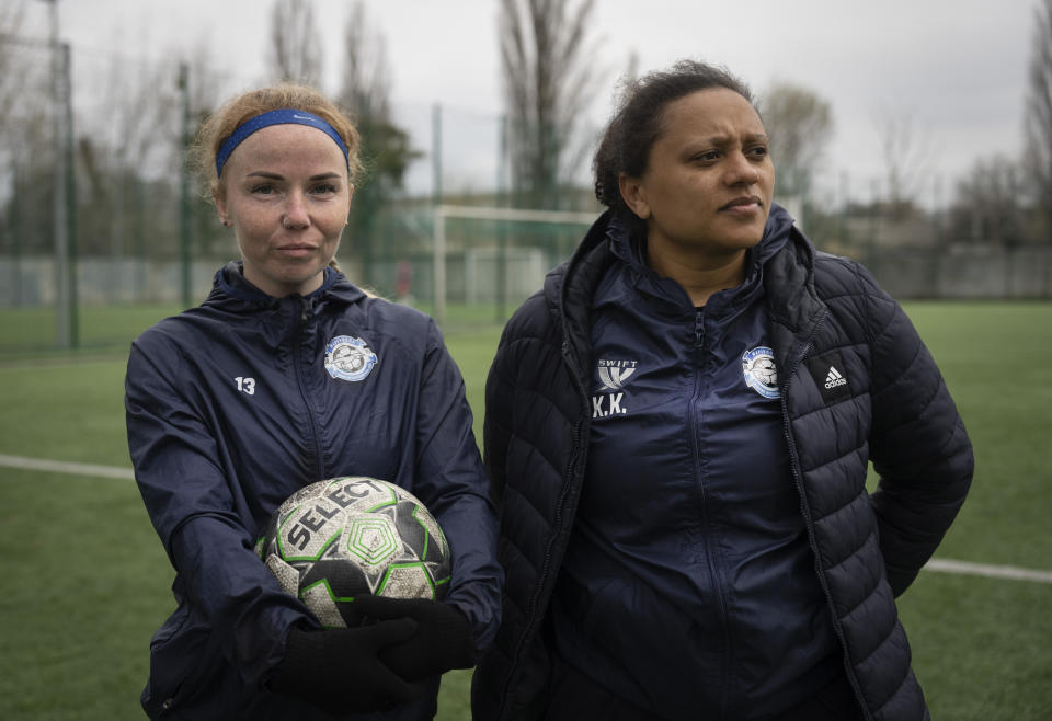 Polina Polukhina, captain of a women's football team from Mariupol, left, and coach Karina Kulakovska on a training session in Kyiv, Ukraine, Thursday, April 13, 2023. After their city was devastated and captured by Russian forces, the team from Mariupol rose from the ashes when they gathered a new team in Kyiv. They continue to play to remind everyone that despite the occupation that will soon hit one year, Mariupol remains a Ukrainian city. (AP Photo/Efrem Lukatsky)