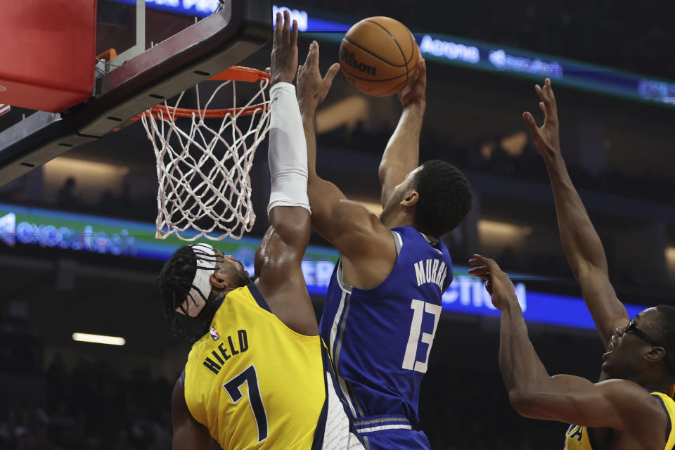 Sacramento Kings forward Keegan Murray (13) shoots against Indiana Pacers guard Buddy Hield (7) during the first half of an NBA basketball game in Sacramento, Calif, Thursday, Jan. 18, 2024. (AP Photo/Jed Jacobsohn)