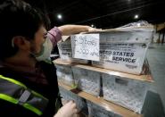 FILE PHOTO: Poll workers prepare absentee ballots for the general election in Raleigh
