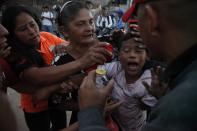 <p>A youth is assisted by bystanders as he reacts to tear gas fired by police during a protest by supporters of presidential candidate Salvador Nasralla in Tegucigalpa, Honduras, Friday, Dec. 1, 2017. (Photo: Fernando Antonio/AP) </p>