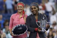 Serena Williams of the U.S. holds her winner's trophy as Victoria Azarenka of Belarus (L) holds the runner up trophy after Williams won their women's singles final match at the U.S. Open tennis championships in New York September 8, 2013. REUTERS/Adam Hunger (UNITED STATES - Tags: SPORT TENNIS)