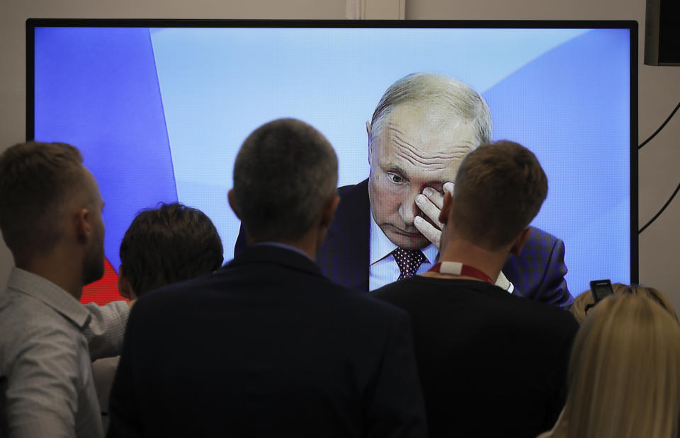 Journalists watch a broadcast of the meeting of Russian President Vladimir Putin and Japanese Prime Minister Shinzo Abe at the Eastern Economic Forum in Vladivostok, Russia, Monday, Sept. 10, 2018. (AP Photo/Dmitri Lovetsky)