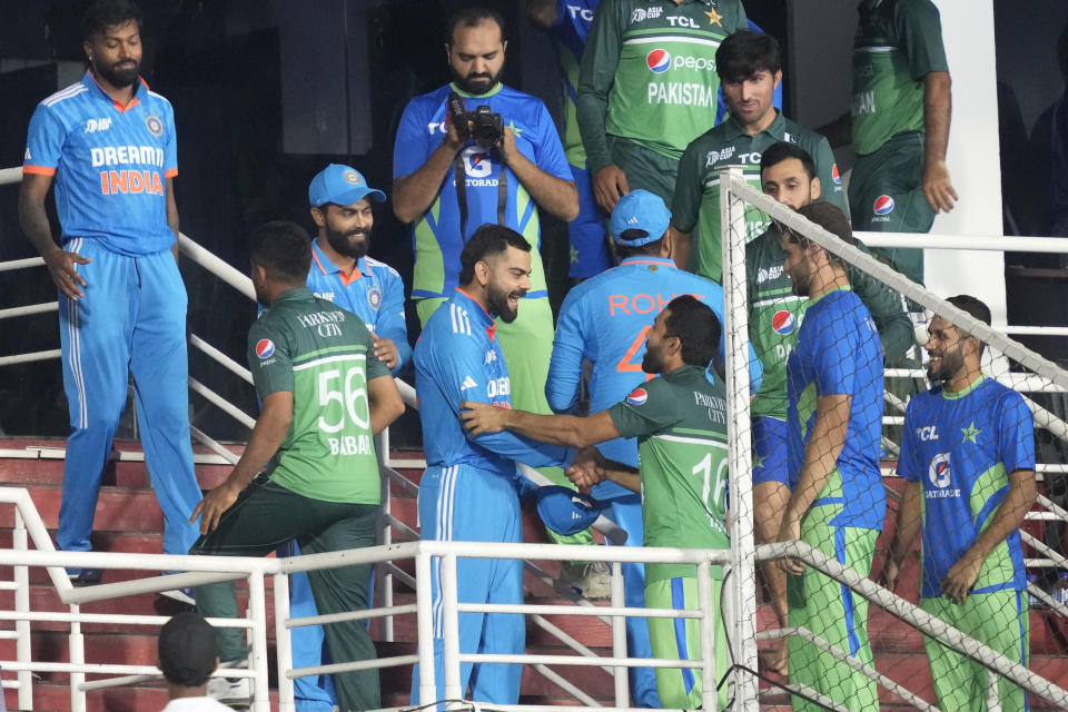 Pakistan's and India's players great each others after the Asia Cup cricket match between India and Pakistan was called off due to rain in Pallekele, Sri Lanka on Saturday, Sep. 2. (AP Photo/Eranga Jayawardena)