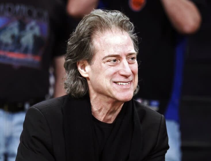 FILE - Comedian Richard Lewis attends an NBA basketball game in Los Angeles on Dec. 25, 2012. Lewis is retiring from stand-up following four surgeries and a diagnosis of Parkinson's disease. The 75-year-old "Curb Your Enthusiasm" star who is known for wearing all-black and exploring his neuroses onstage posted a video Monday to Twitter explaining his various health issues. (AP Photo/Alex Gallardo, File)