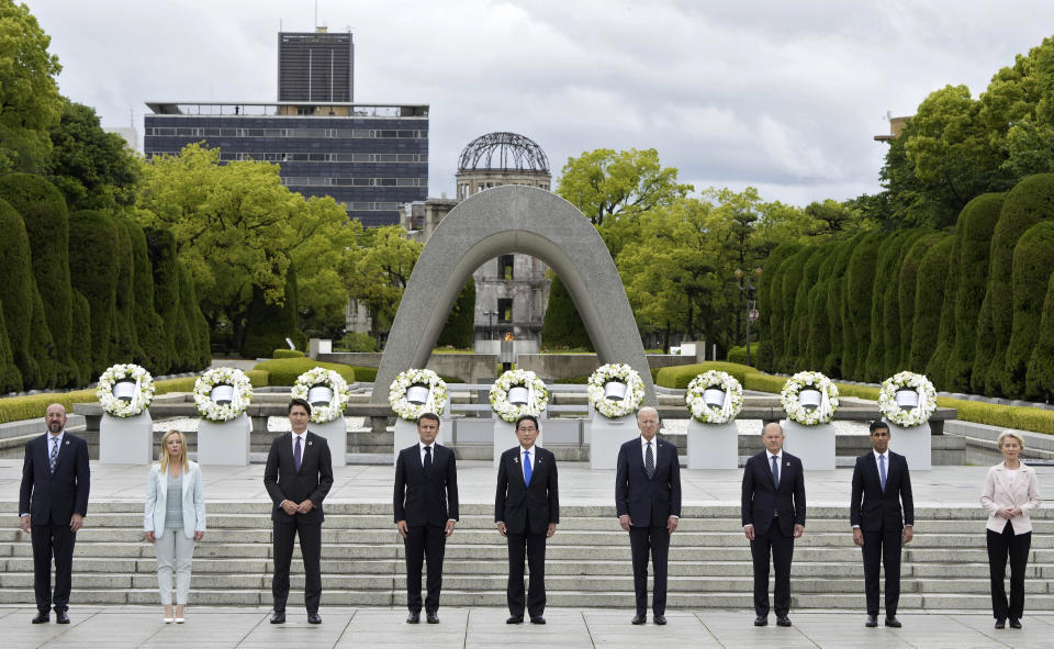 From left to right, European Council President Charles Michel, Italian Prime Minister Giorgia Meloni, Canadian Prime Minister Justin Trudeau, French President Emmanuel Macron, Japan's Prime Minister Fumio Kishida, U.S. President Joe Biden, German Chancellor Olaf Scholz, British Prime Minister Rishi Sunak, European Commission President Ursula von der Leyen pose for a group photo after laying flower wreaths at the cenotaph for Atomic Bomb Victims in the Peace Memorial Park as part of the G7 Hiroshima Summit in Hiroshima, Japan, Friday, May 19, 2023. (Franck Robichon/Pool Photo via AP)