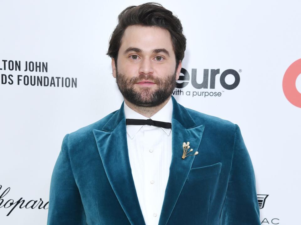 Jake Borelli wearing a blue suit.