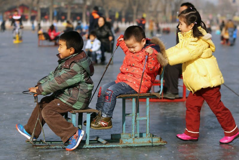Families visit a frozen lake to skate, ski, slip and fall at a popular tourist area in Beijing on February 6, 2015. On October 29, 2015, China announced it was ending its nearly 40-year one-child policy, allowing couples to have two children without facing punishment. File Photo by Stephen Shaver/UPI