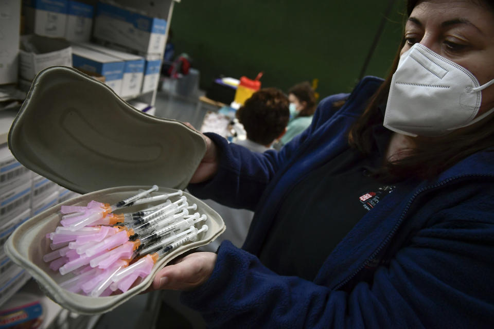 A health worker prepares Pfizer vaccines before people receive a shot during a COVID-19 vaccination campaign, in Pamplona, northern Spain, Friday, May 7, 2021.(AP Photo/Alvaro Barrientos)