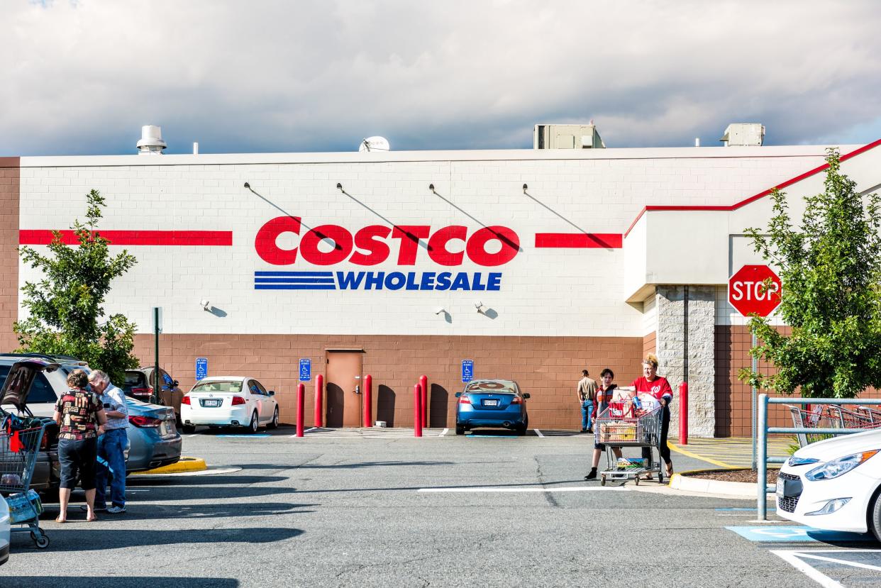 Fairfax: People with shopping carts filled with groceries goods, products walking out of Costco store in Virginia in parking car lot