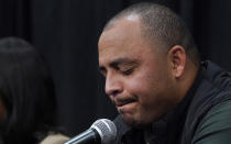 University of Virginia head football coach, Tony Elliott, holds his emotions in check as he speaks to the media during a press conference concerning the killing of three football players as well as the wounding of two others at the University of Virginia Tuesday Nov. 15, 2022, in Charlottesville. Va. Authorities say three people have been killed and two others were wounded in a shooting at the University of Virginia and a student suspect is in custody. (AP Photo/Steve Helber)