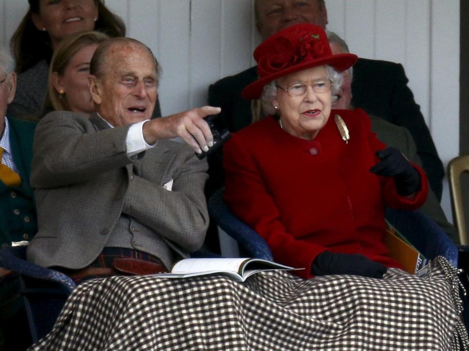 Queen Elizabeth and Prince Philip watch the Braemar Highland Gathering in 2015.