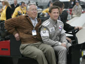 FILE - In this May 14, 2008, file photo, John Andretti, right, rides out to the pit area with his father, Aldo Andretti, for practice for the Indianapolis 500 auto race at Indianapolis Motor Speedway in Indianapolis. Mario Andretti feels the same pain as so many others these days. His wife died two years ago, long before the pandemic. And his beloved nephew John lost a brutal battle with colon cancer. But then COVID-19 claimed his twin brother Aldo and one of the greatest racers of all time is not immune from the loneliness and depression sweeping the world. (AP Photo/AJ Mast, File)